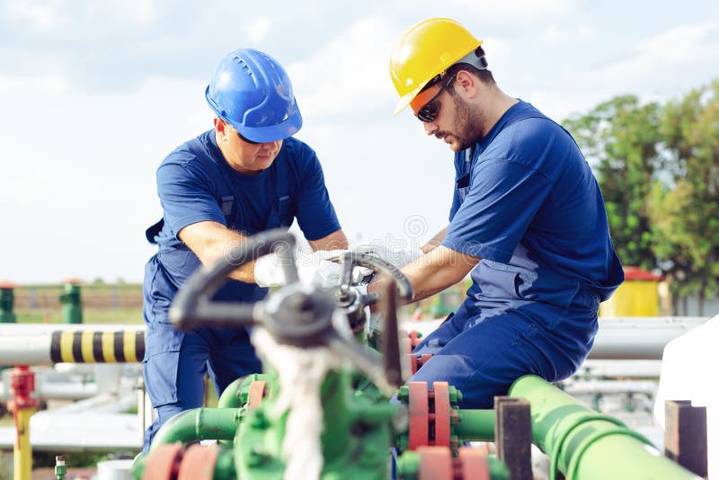 Two engineers working inside oil and gas refinery royalty free stock photography