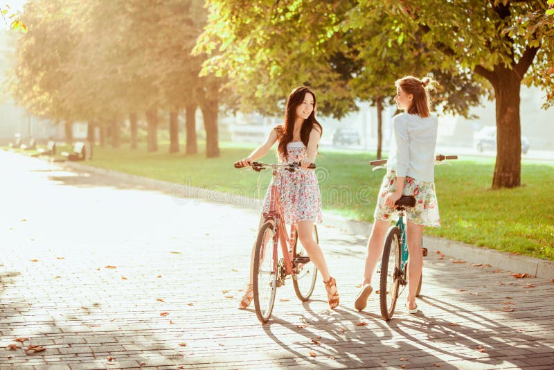 The Two Young Girls with Bicycles in Park Stock Photo Image of