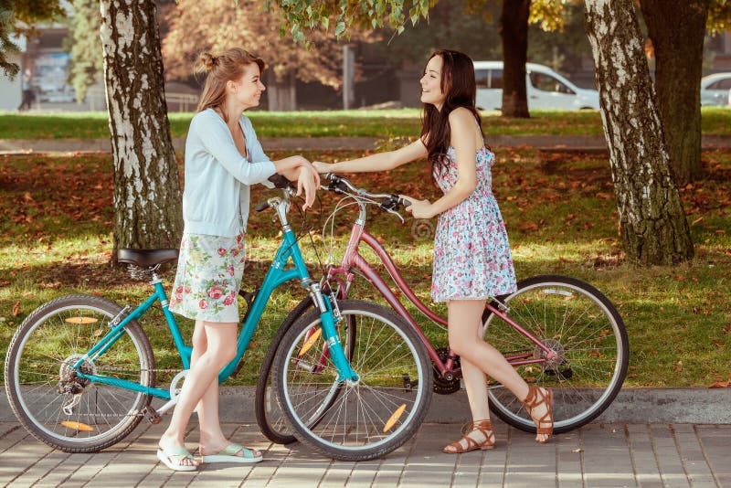The Two Young Girls with Bicycles in Park Stock Photo Image of