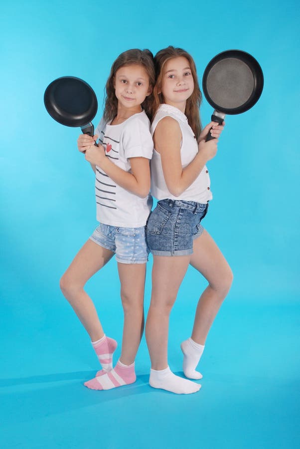 Two young girls with a frying pan