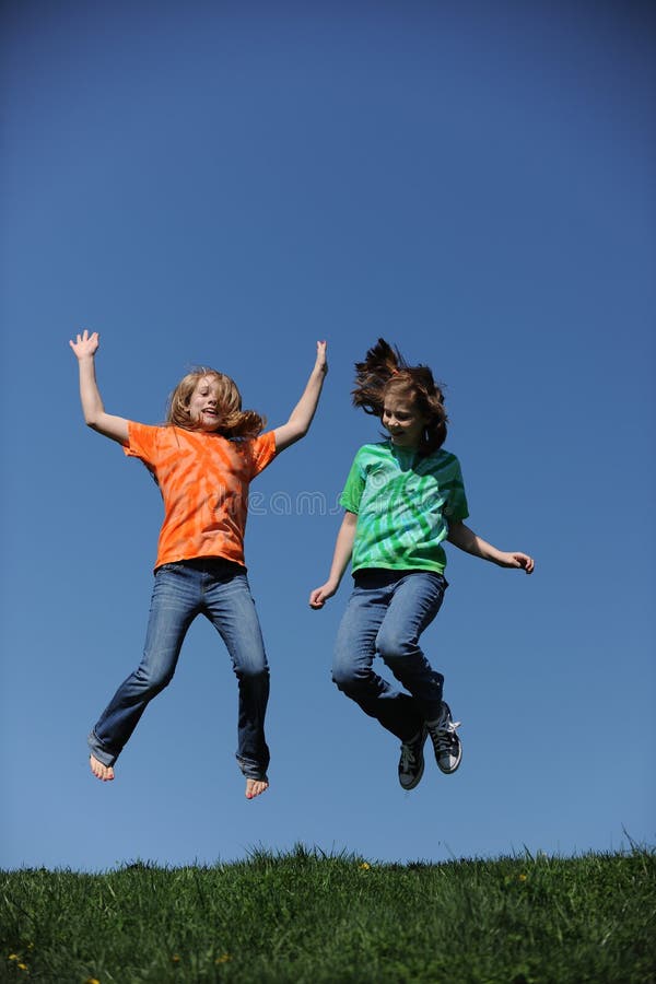 Two young Girls jumping
