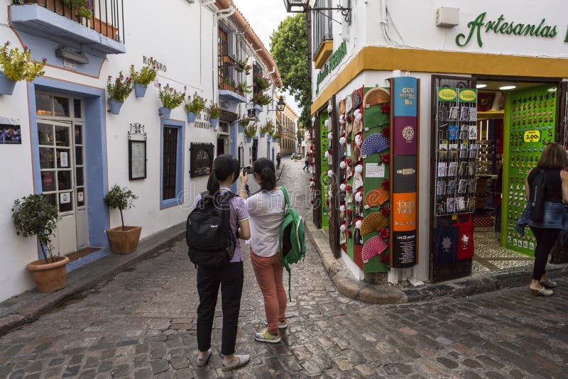 Two young girls take photo in the Romero street, jewish quarter