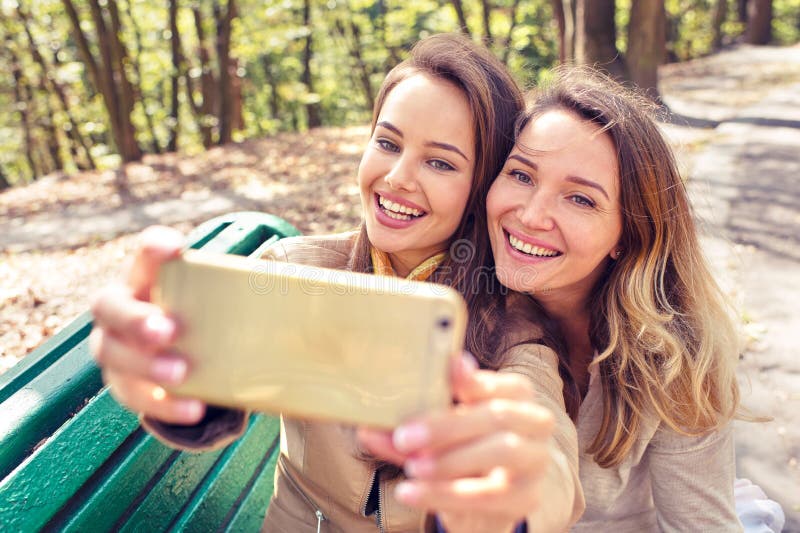 Two young girls taking photos making selfie royalty free stock photography Two young girls taking photos making selfie royalty free stock photography