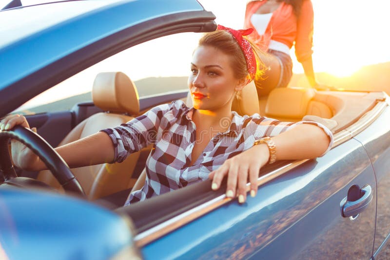 Two young happy girls driving a cabriolet royalty free stock photos Two young happy girls driving a cabriolet royalty free stock photos