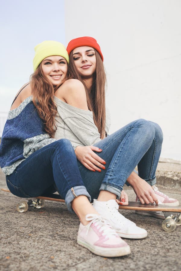 Two young longboarding girl friends. 