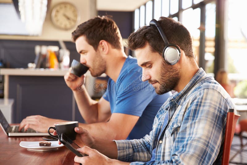 Two young men. Man working on Computer.