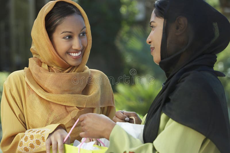 Two Young Muslim Women Talking Outdoors stock photos Two Young Muslim Women Talking Outdoors stock photos