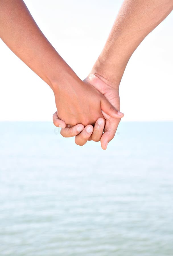 Two Young People Holding Hands By Water Stock Photo Image Of Summer