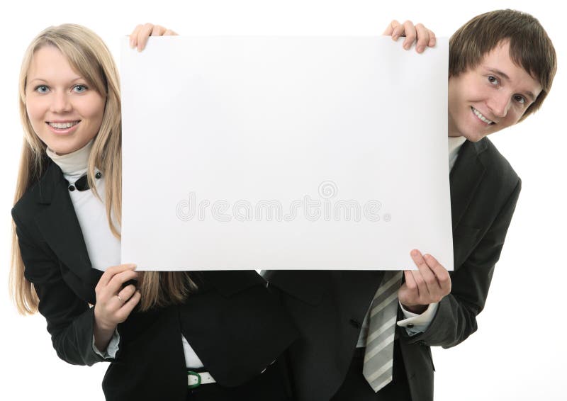 Two young people holding a white sign