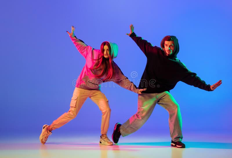 Two Young People, Man and Woman Dancing Brakedance, Hip-hop Over Blue  Background in Neon Light. Stock Image - Image of face, body: 227499251