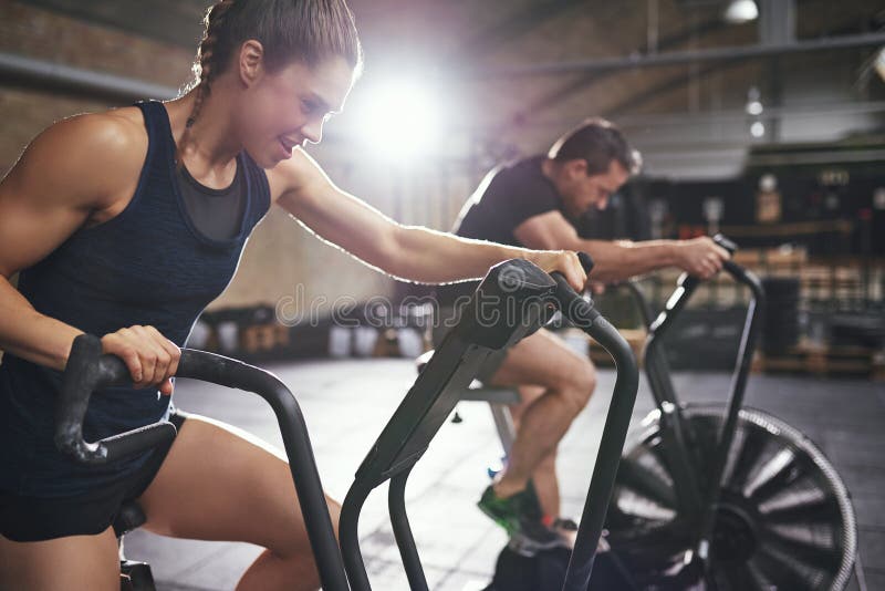 Two young people training toughly on simulators royalty free stock photo Two young people training toughly on simulators royalty free stock photo