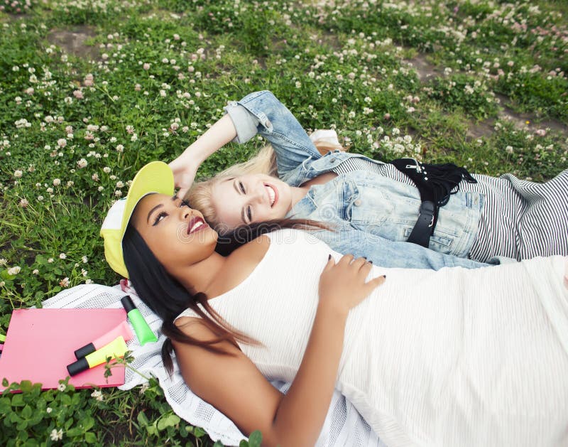 Two Young Pretty Teenager Girls Best Friends Laying On Grass Making