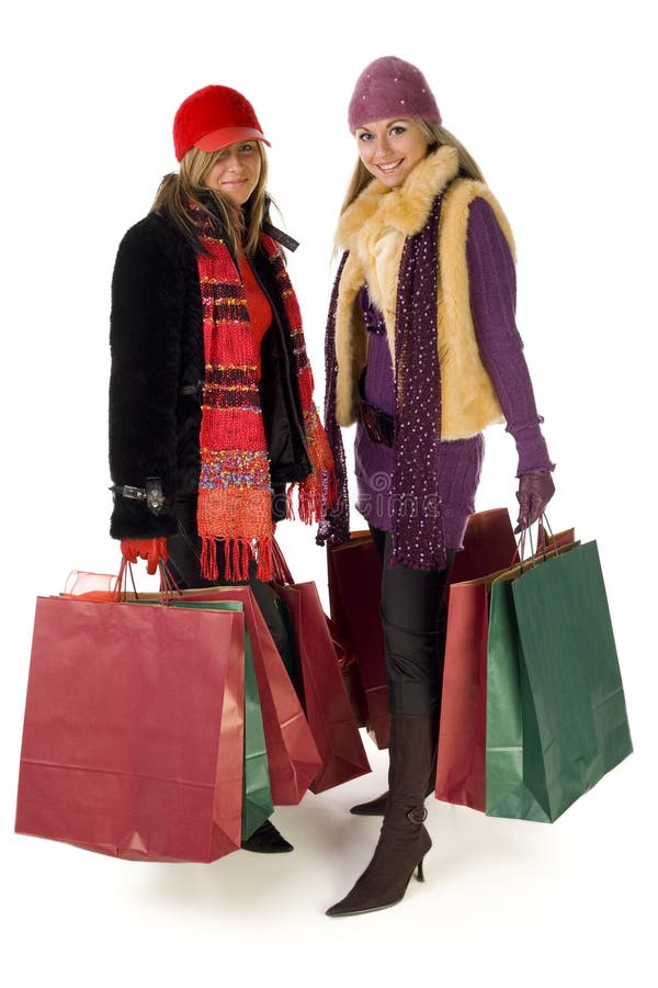 Two young women shopping and smiling. Front view, isolated on white background. Two young women shopping and smiling. Front view, isolated on white background.