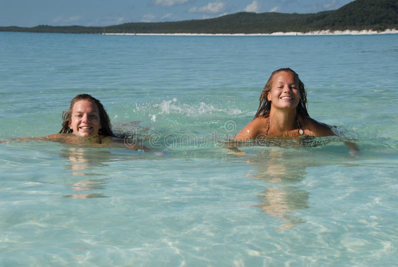 Two young teenage girls swiming in paradise water