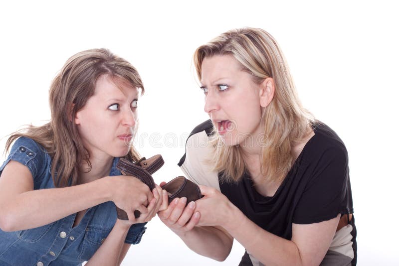 Two young woman are fighting each other