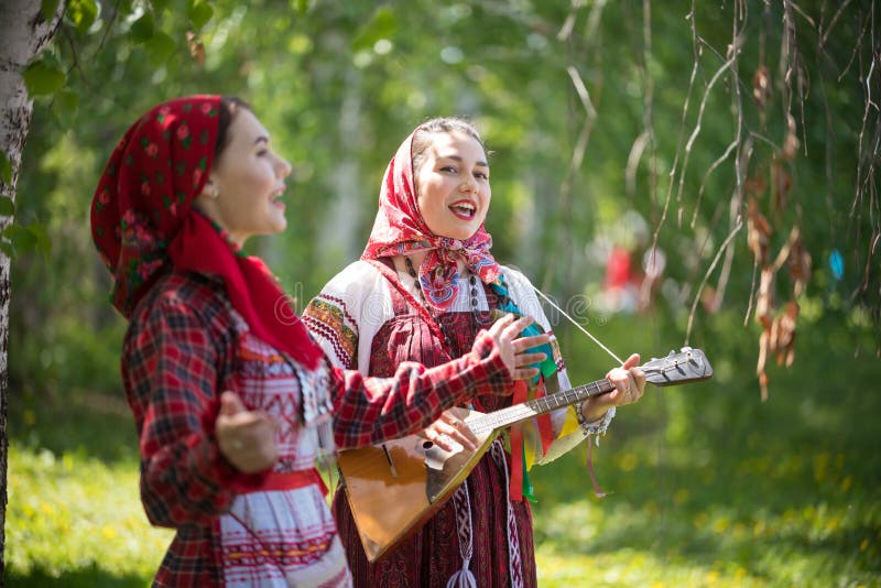 Two Young Woman in Traditional Russian Clothes Singing in the Forest ...