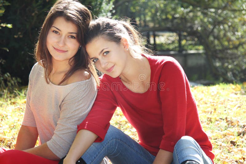 Two young women on autumn background