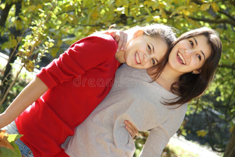 Two young women on autumn background