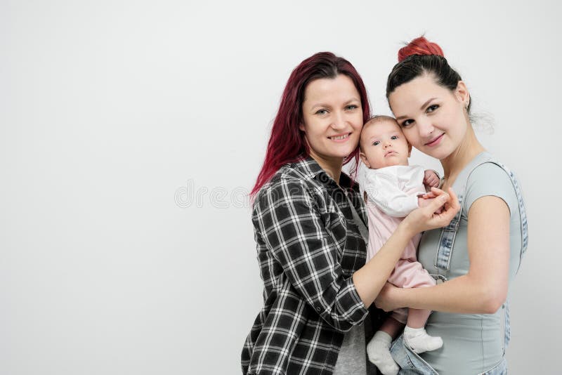 Two Young Women with a Baby on a White Background