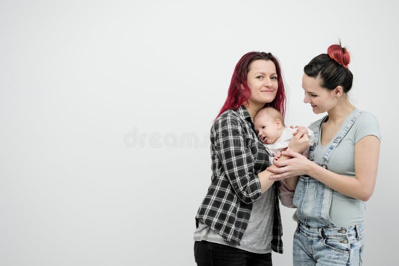 Two Young Women with a Baby on a White Background