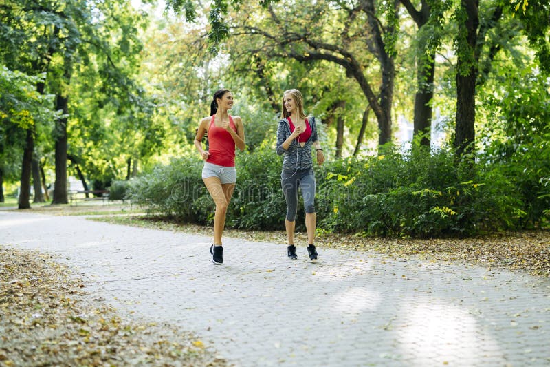 Two young women jogging stock photo. Image of friends - 133547054