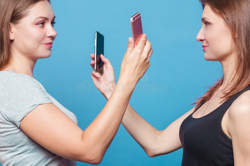 Two young women make the photo of eath other stock photography Two young women make the photo of eath other stock photography