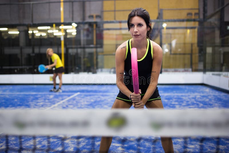 Two Young Women Playing Paddle Tennis. Stock Photo Image of leisure
