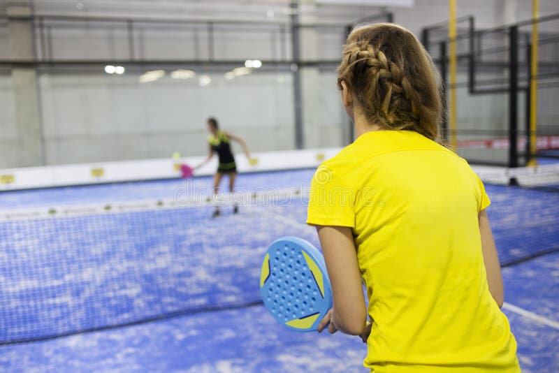 Two Young Women Playing Paddle Tennis. Stock Photo Image of female