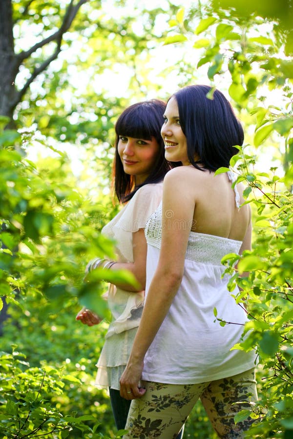 Two young women posing in a summer park