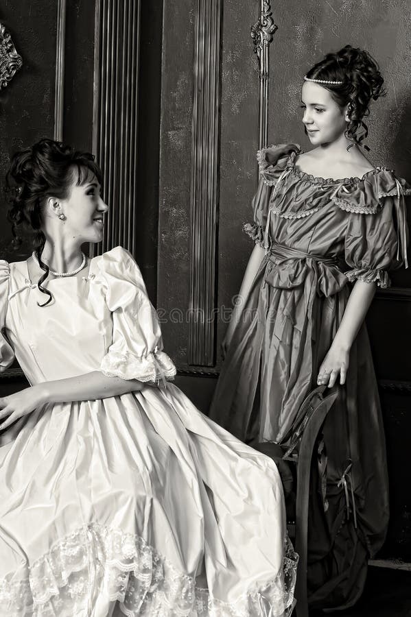 Two young women in retro dresses stock photos Two young women in retro dresses stock photos
