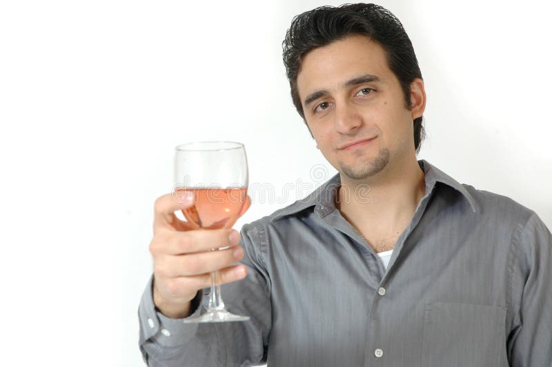 A man raises his glass to toast. Man isolated on white background. Man with a happy smile on his face holding a glass of wine out in front of him. A man raises his glass to toast. Man isolated on white background. Man with a happy smile on his face holding a glass of wine out in front of him.