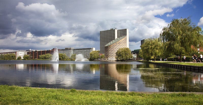 This is a photo of the famous Tycho Brahe Planetarium in Copenhagen (Vesterbro quarter) taken from across the lake. It is an architectural gem and one of the more unique buildings in the city. The dramatic weather makes it stand out even more and provides an almost mysterious feel. This is a photo of the famous Tycho Brahe Planetarium in Copenhagen (Vesterbro quarter) taken from across the lake. It is an architectural gem and one of the more unique buildings in the city. The dramatic weather makes it stand out even more and provides an almost mysterious feel.