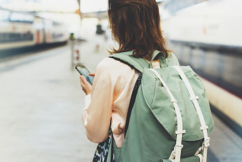 Tycka om lopp Ung nätt kvinna som väntar på stationsplattformen med ryggsäcken på det elektriska drevet för bakgrund genom att an royaltyfria bilder Tycka om lopp Ung nätt kvinna som väntar på stationsplattformen med ryggsäcken på det elektriska drevet för bakgrund genom att an royaltyfria bilder
