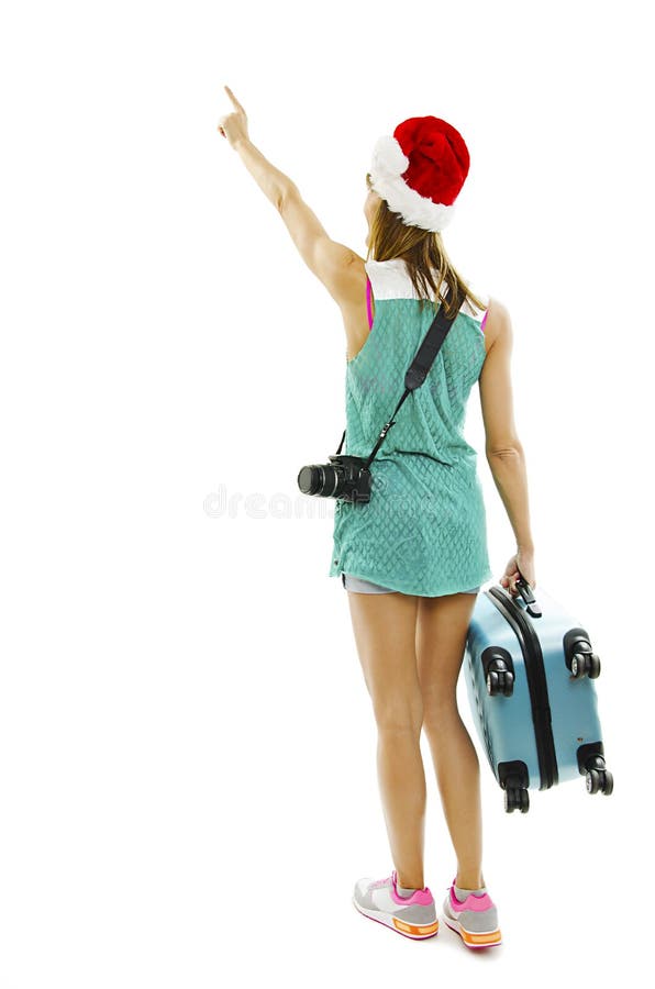 Tylny widok podróżnik w Santa kapeluszu z kamerą i walizką, punkty przy ścianą obrazy stock Tylny widok podróżnik w Santa kapeluszu z kamerą i walizką, punkty przy ścianą obrazy stock