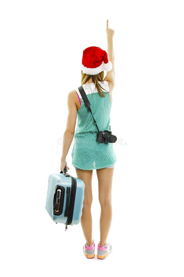 Tylny widok podróżnik w Santa kapeluszu z kamerą i walizką, punkty przy ścianą zdjęcie royalty free Tylny widok podróżnik w Santa kapeluszu z kamerą i walizką, punkty przy ścianą zdjęcie royalty free