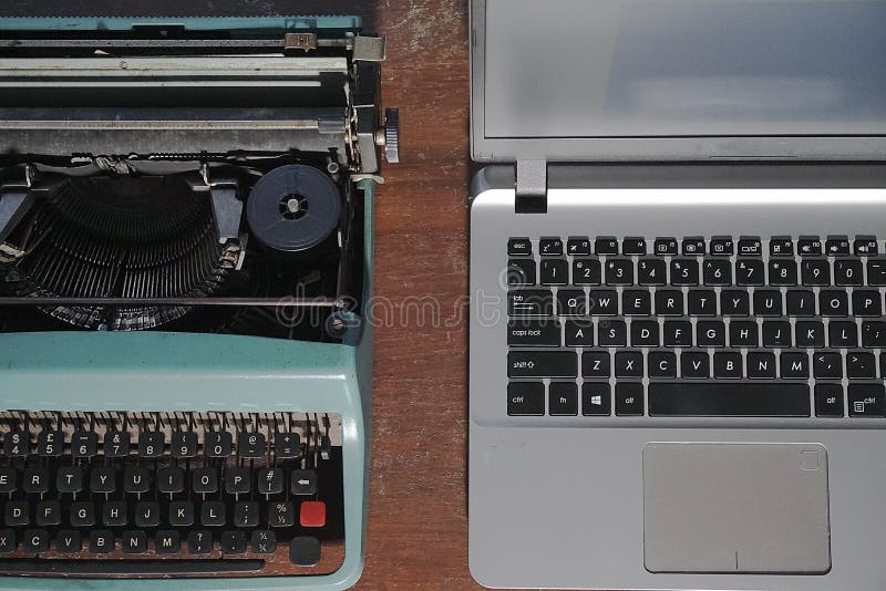 Typewriter vs Laptop stock image. Image of technology 259710711