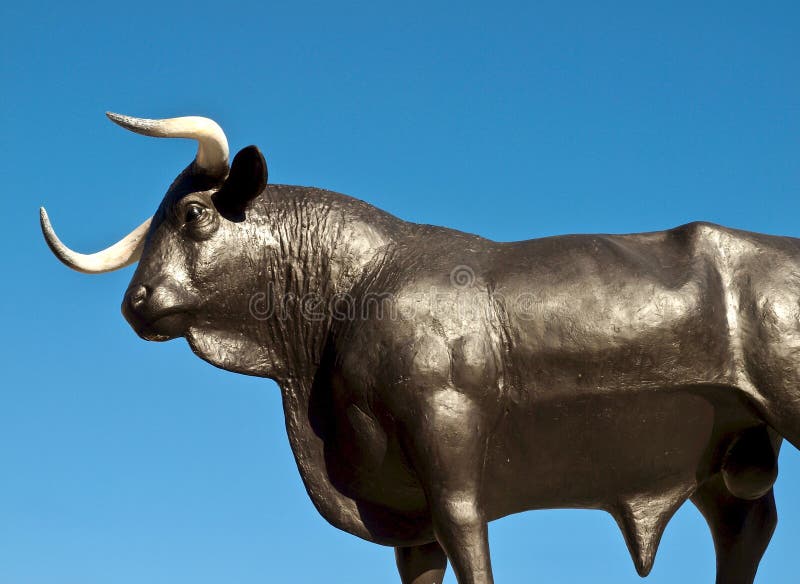 Typical Black Bull Sculpture in Front of Blue Sky Stock Photo Image