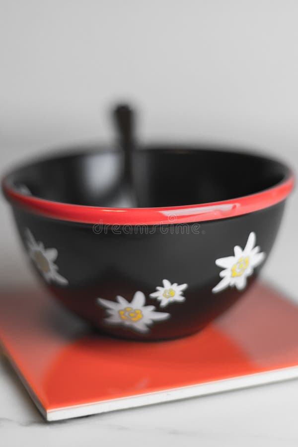 Typical black swiss cereal bowl with edelweiss on the side on a stock photo Typical black swiss cereal bowl with edelweiss on the side on a stock photo