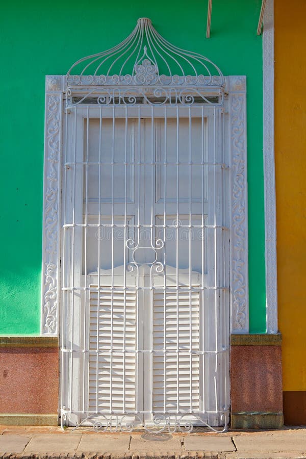 Typical colonial building with white window iron grate, Cuba