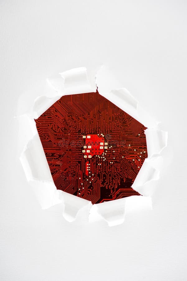 Typical desktop computer logic board close-up view through ripped paper royalty free stock photography