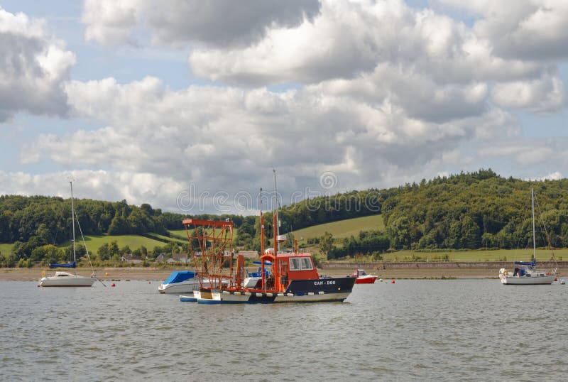 Exmouth, Devon Sailing Boats Anchored at Low Tide. Clouds Editorial