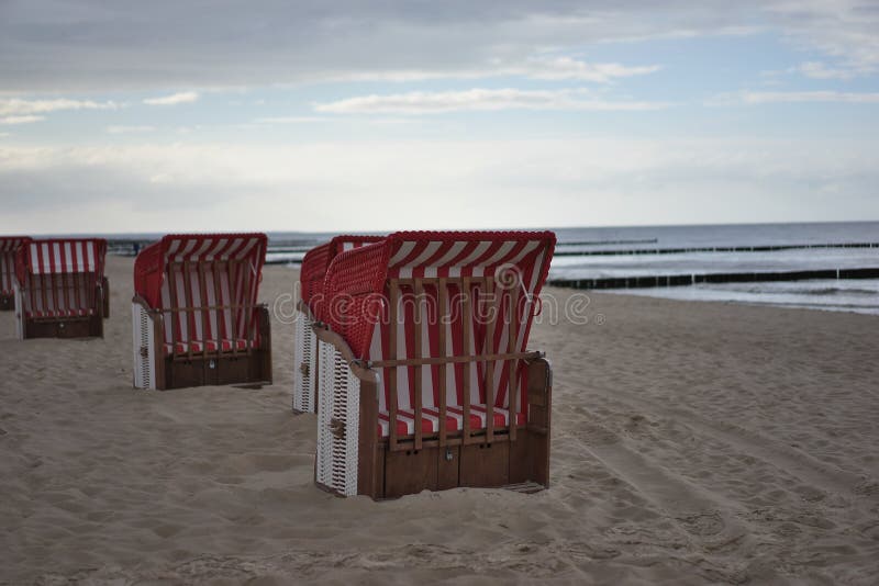 Typical german beach chairs or beach chairs baskets on the beach of Nord or Baltic sea in the evening royalty free stock photography Typical german beach chairs or beach chairs baskets on the beach of Nord or Baltic sea in the evening royalty free stock photography