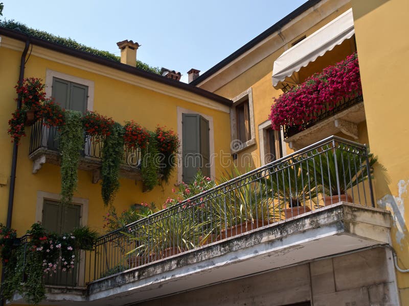 Typical Italian house balcony with flowers