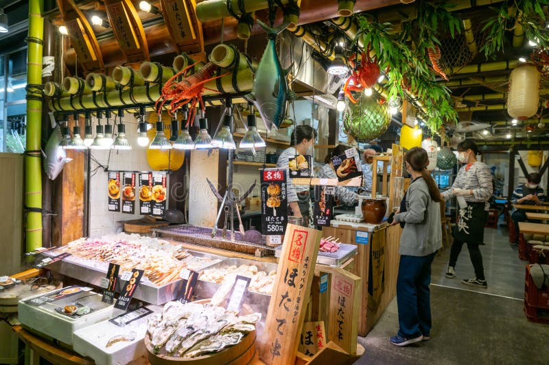 Nishiki Market, Kyoto, Japan. Displays with freshly prepared oysters, crabs, prawns, lobster and more. stock photo