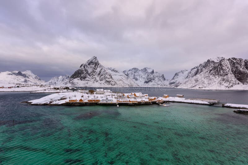 Typical Norwegian landscape. Beautiful view of scenic Lofoten Islands winter scenery with traditional yellow fisherman Rorbuer cab. Ins in the historic village stock image Typical Norwegian landscape. Beautiful view of scenic Lofoten Islands winter scenery with traditional yellow fisherman Rorbuer cab. Ins in the historic village stock image