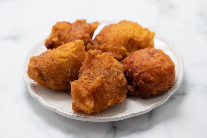 Typical portuguese Christmas sweets Sonhos on white dish royalty free stock photography