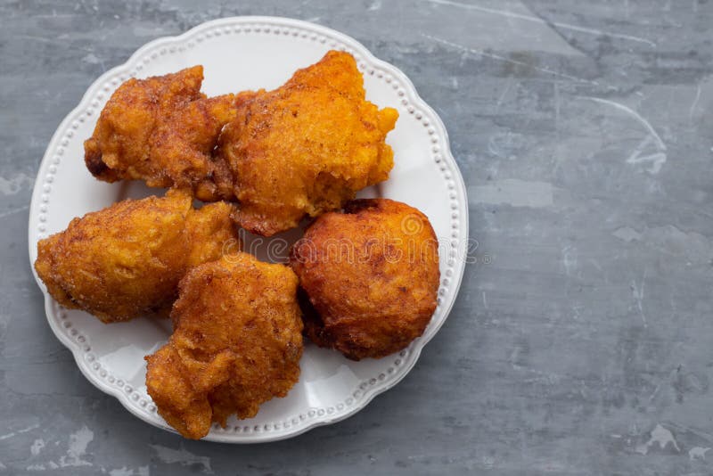 Typical portuguese Christmas sweets Sonhos on white dish on ceramic background stock photo