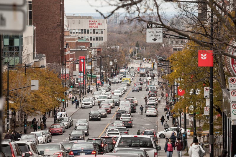 Typical Shopping street in Cote des Neiges district, with small and medium businesses, cars passing by in a traffic jam stock photos Typical Shopping street in Cote des Neiges district, with small and medium businesses, cars passing by in a traffic jam stock photos