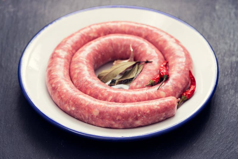Typical Spanish Sausage on White Dish on Ceramic Background Stock Image