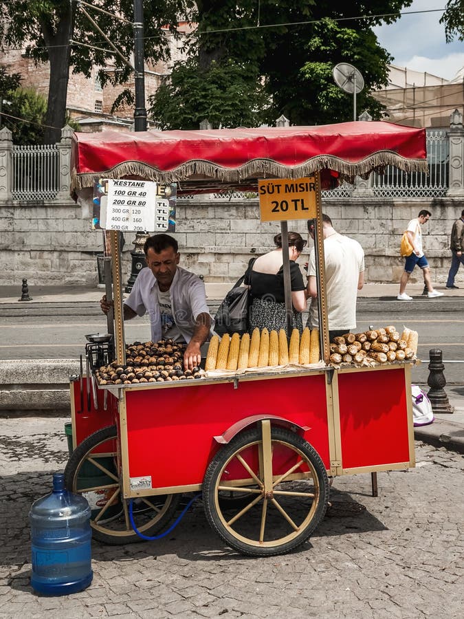 a typical Turkish vendor with his cart selling corn on the cob and chestnuts to tourists. a typical Turkish vendor with his cart selling corn on the cob and chestnuts to tourists